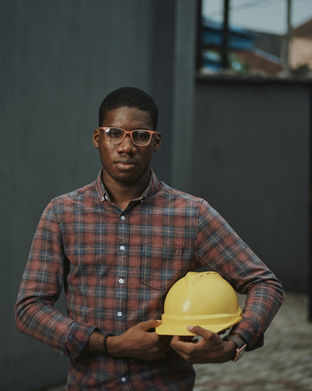 An engineer holding his hard hat