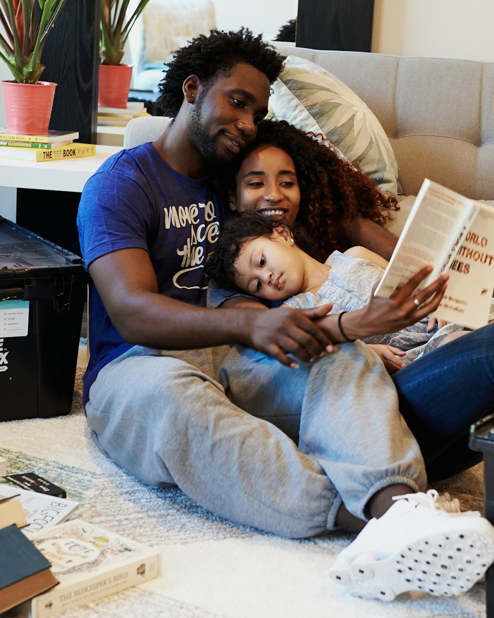 A father reading with his children on the sofa