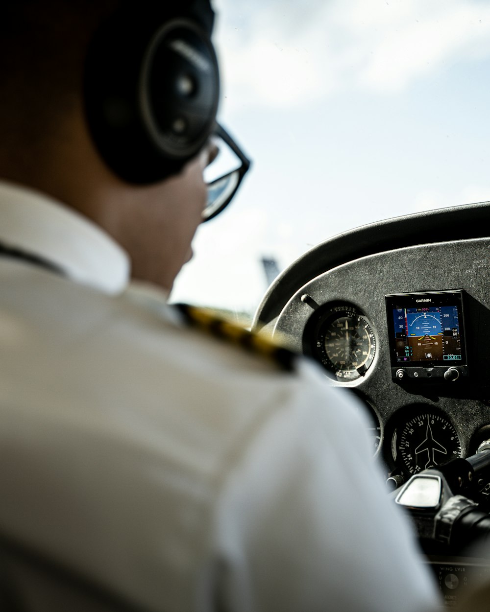 A pilot at the controls in the cockpit