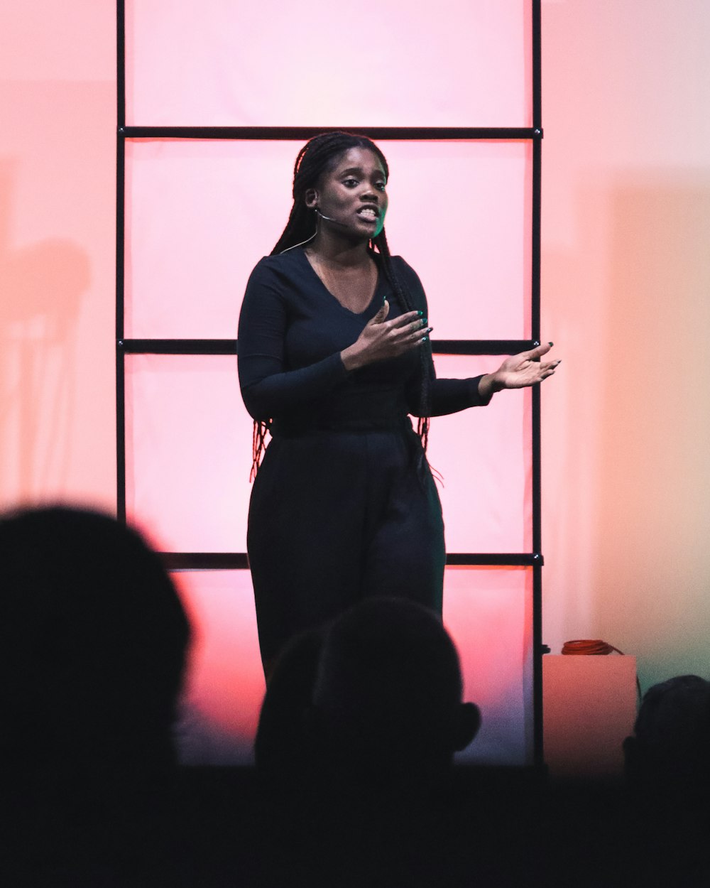 A woman speaking on stage with a microphone